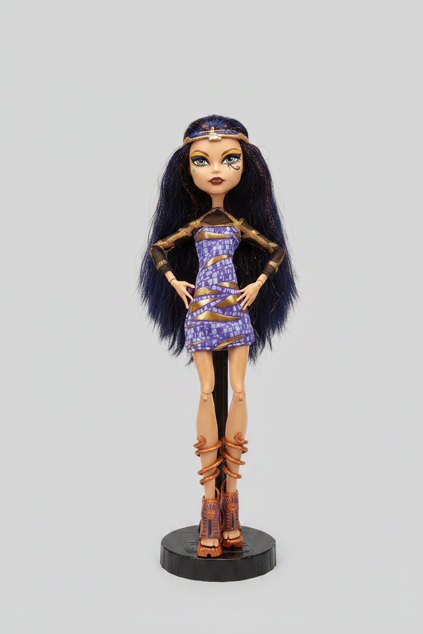Monster High doll with dark hair and purple dress on a black background