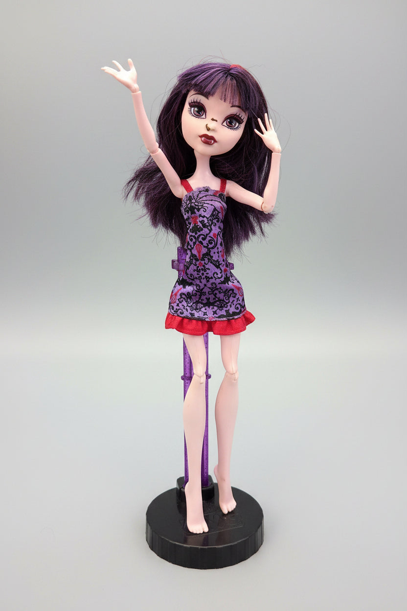 Doll with purple hair and a purple dress on a black background