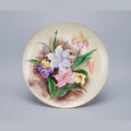 Decorative plate with floral design on a black background