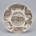 Decorative plate with illustrations of landmarks and text on a dark background