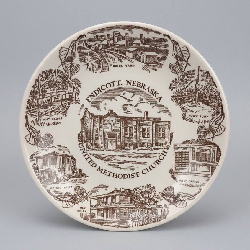 Decorative plate with illustrations of landmarks and text on a dark background