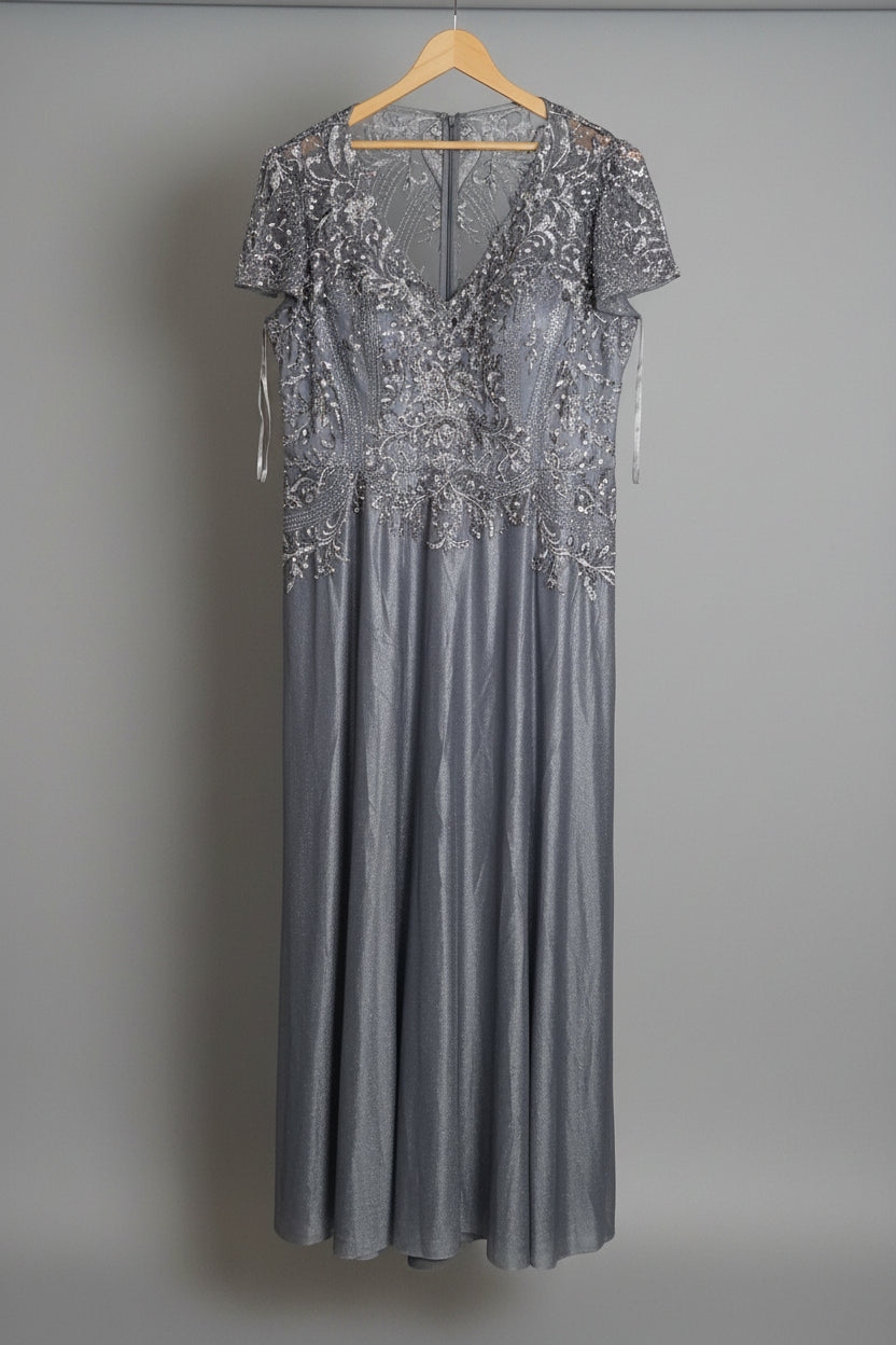 Silver evening gown on a hanger with boxes in the background