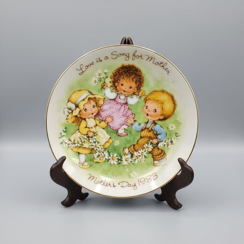 Decorative plate with children illustration and text on a dark background