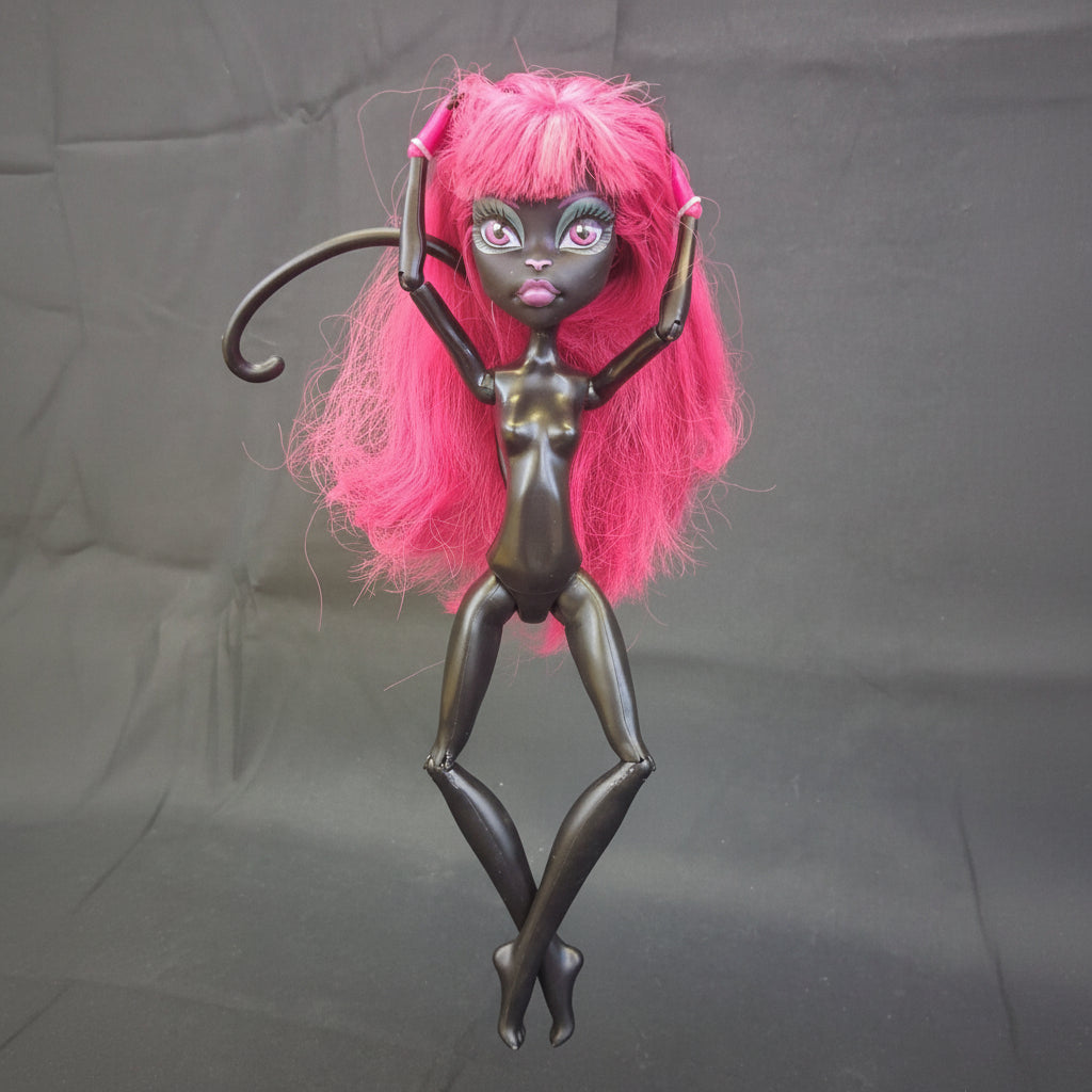 Toy figure with pink hair and a purple sword on a black background