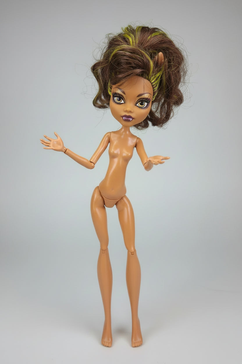 Toy doll with brown and green hair, purple outfit, on a dark background