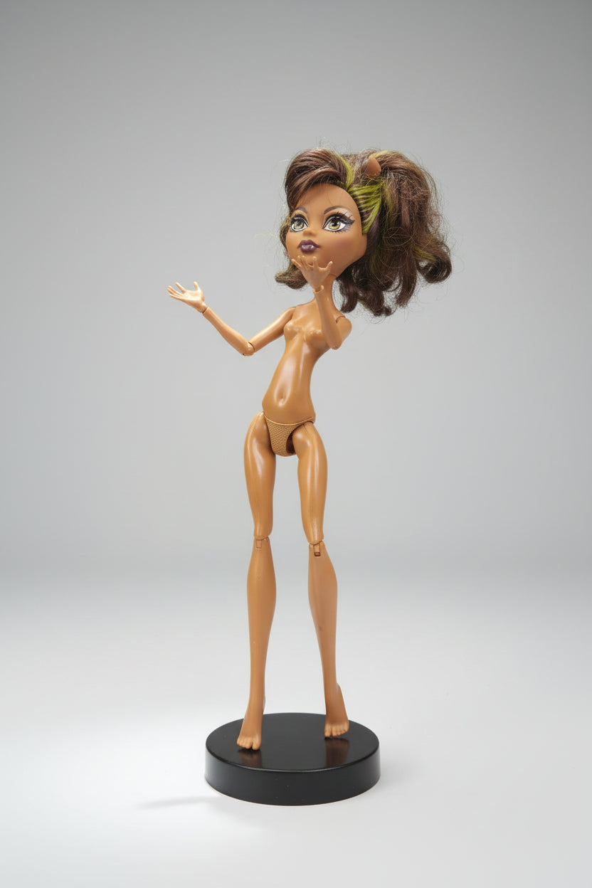 Toy figure with a long purple dress on a black background