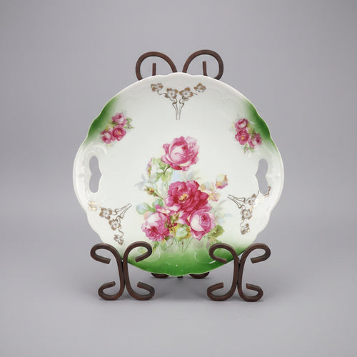 Decorative ceramic plate with floral design on a black background
