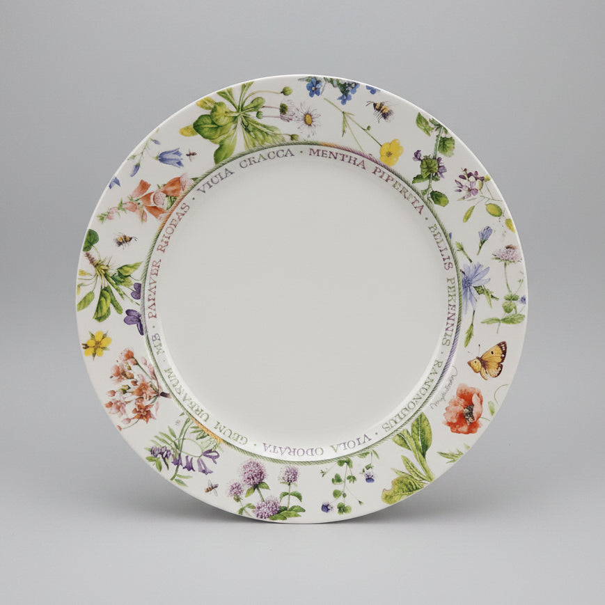 Decorative plate with floral and butterfly design on a black background
