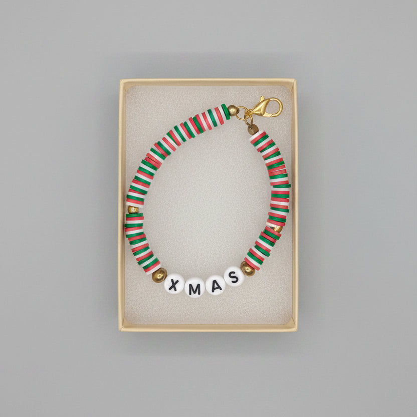 Beaded Christmas-themed necklace with 'XMAS' letters in a display box.