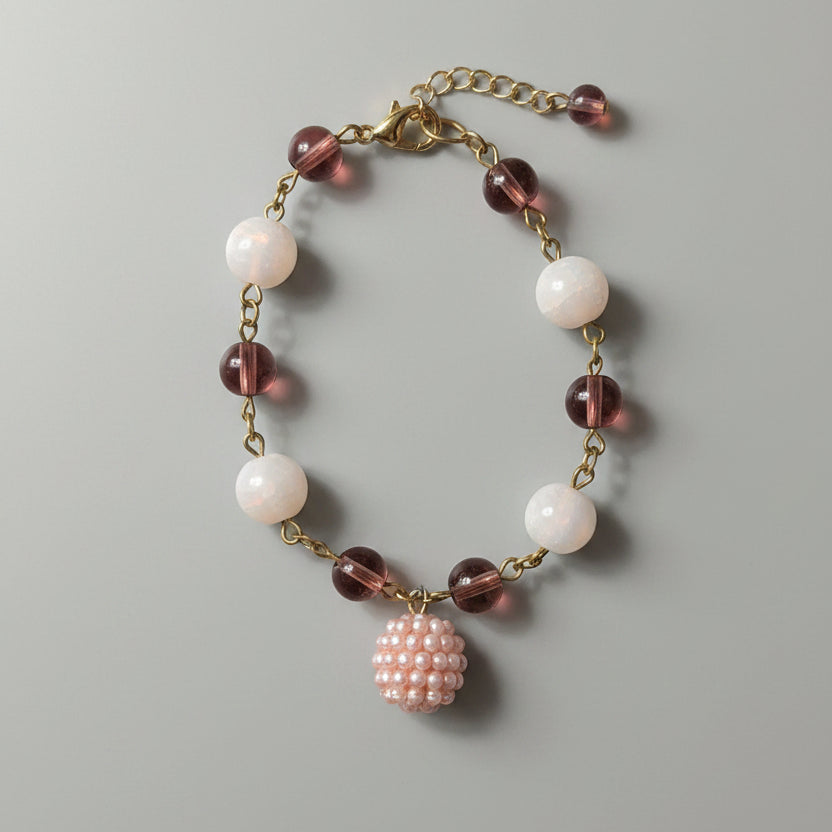 Bracelet with pink and white beads on a light gray background