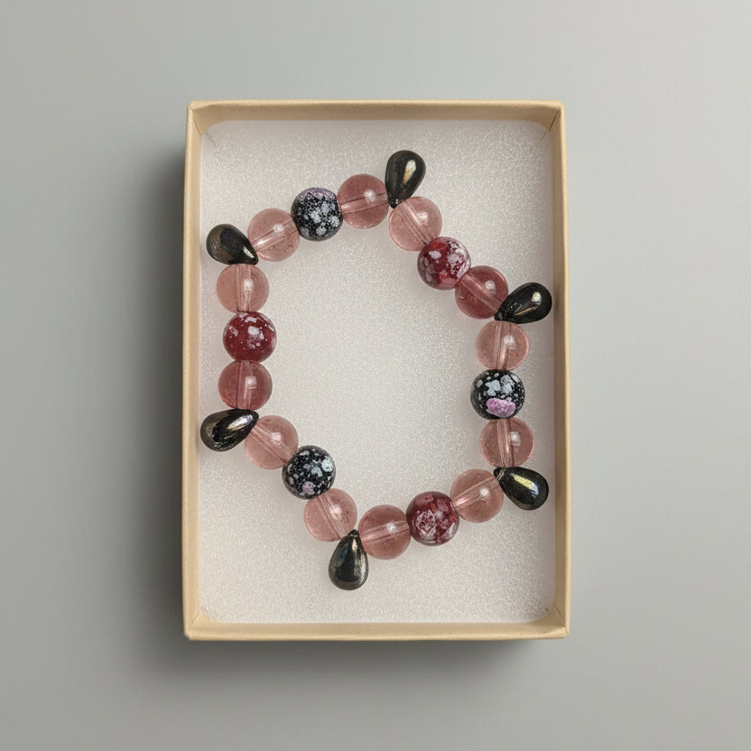 Beaded bracelet on a display card with other jewelry items in the background