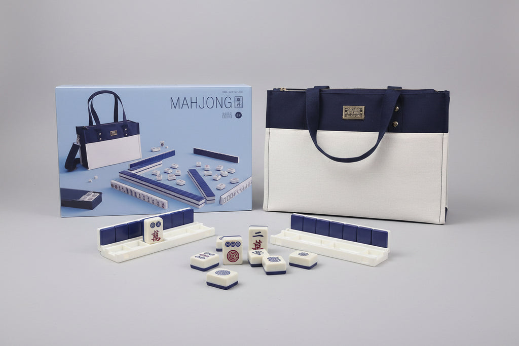 Mahjong set with packaging and carrying case on a dark background