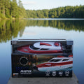 Boxed high-speed RC boat with branding on a dark background