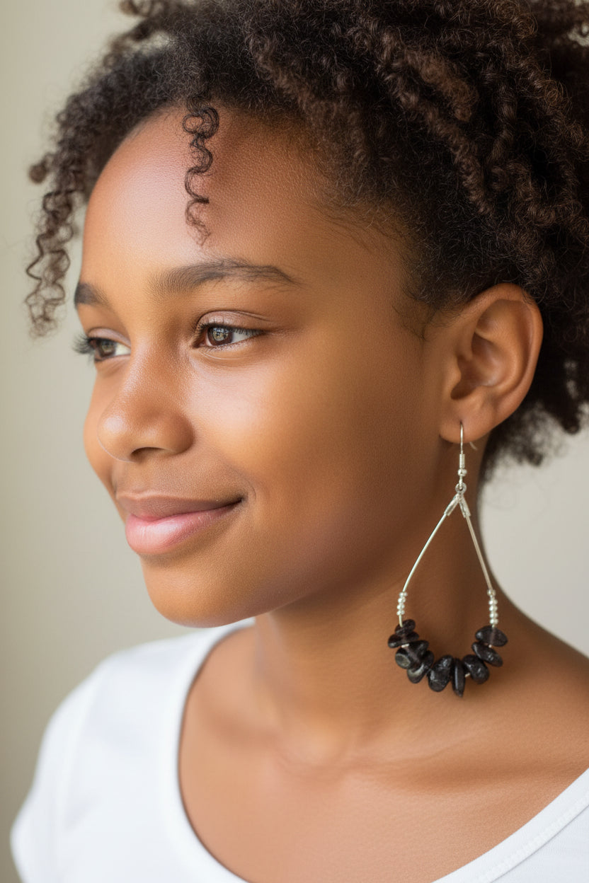 Pair of beaded earrings on a brown card with a clear plastic cover.