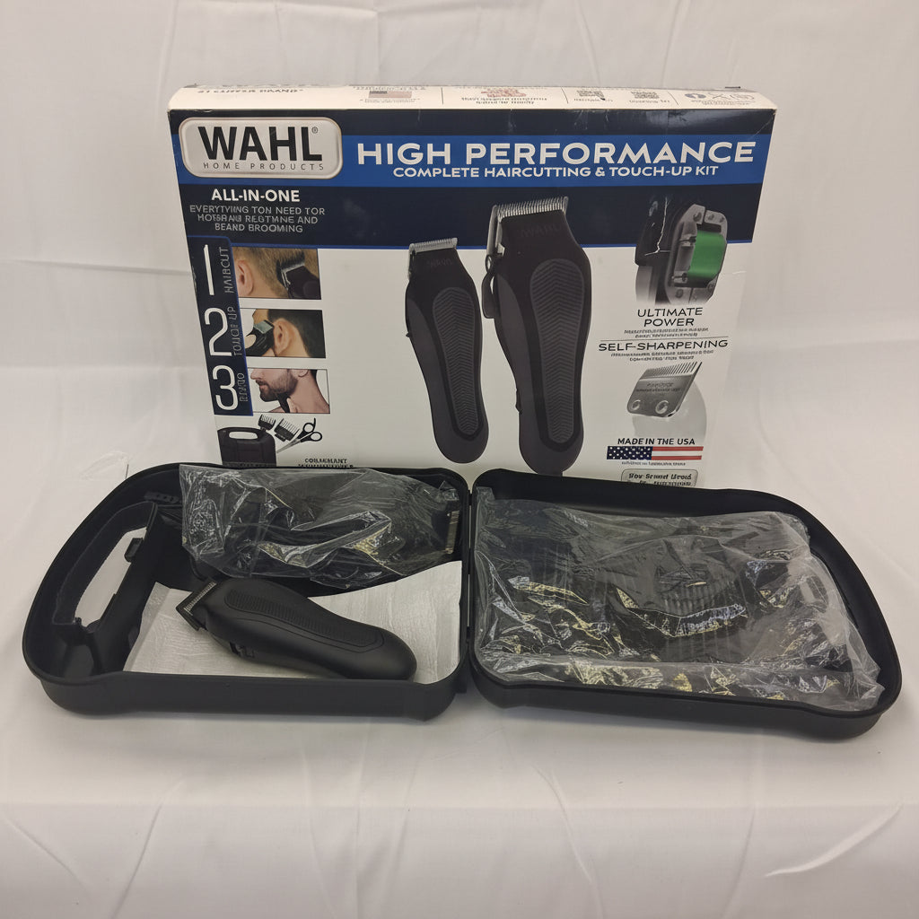 Wahl high performance all-in-one complete haircutting and touch-up kit, shown with its retail box and the opened carrying case containing the black electric clippers and multiple black and silver blades.