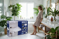 Broan 80 CFM bath fan packaging with images of a bathroom and product features.